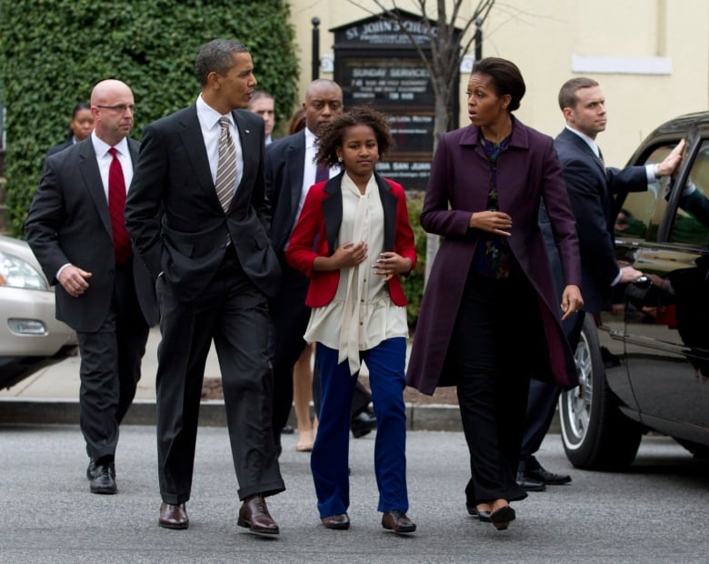 Then U.S. president Barack Obama talks to first lady Michelle Obama as they and daughter Sasha, walking between them, head back to the White House accompanied by Secret Service officers in Mar. 2012. Obama reinstated the lifetime protection for former presidents. 