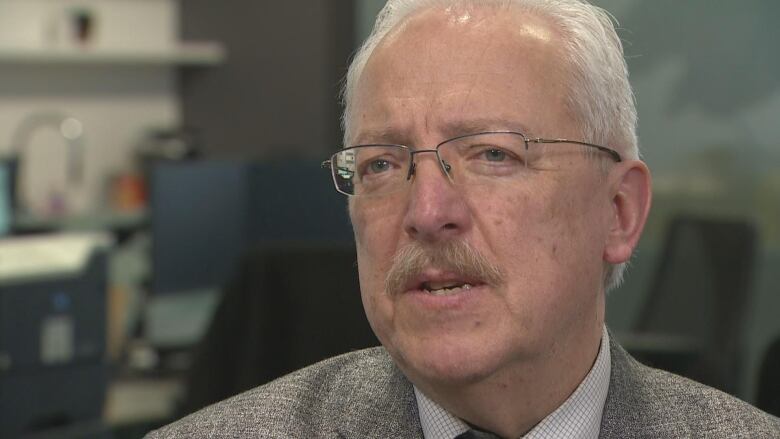 A close up of a man with a moustache.