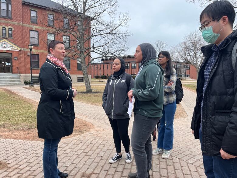 Margot Rejskind, an instructor in UPEI's faculty of music and faculty association negotiator, speaks with students on the campus Monday.