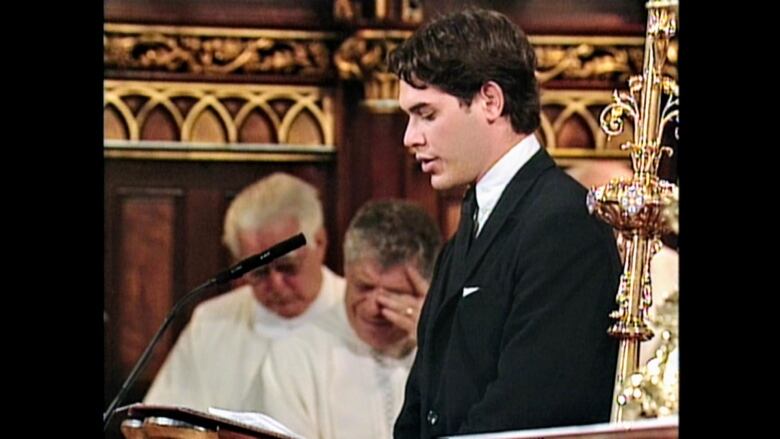 Alexander Green performing a reading at the funeral of Pierre Elliott Trudeau. 