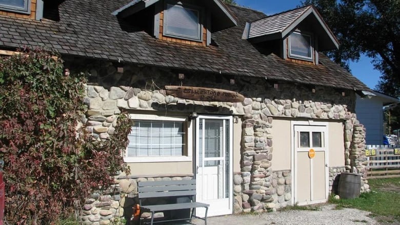 The exterior of a stone-covered building.