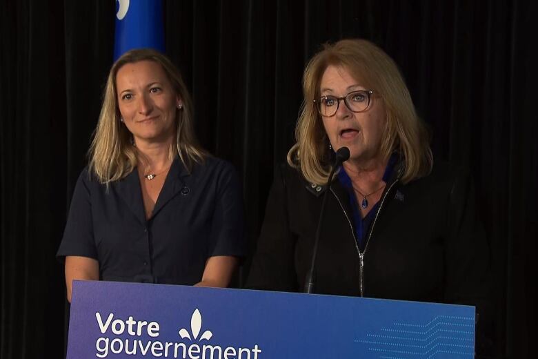 two women at a podium