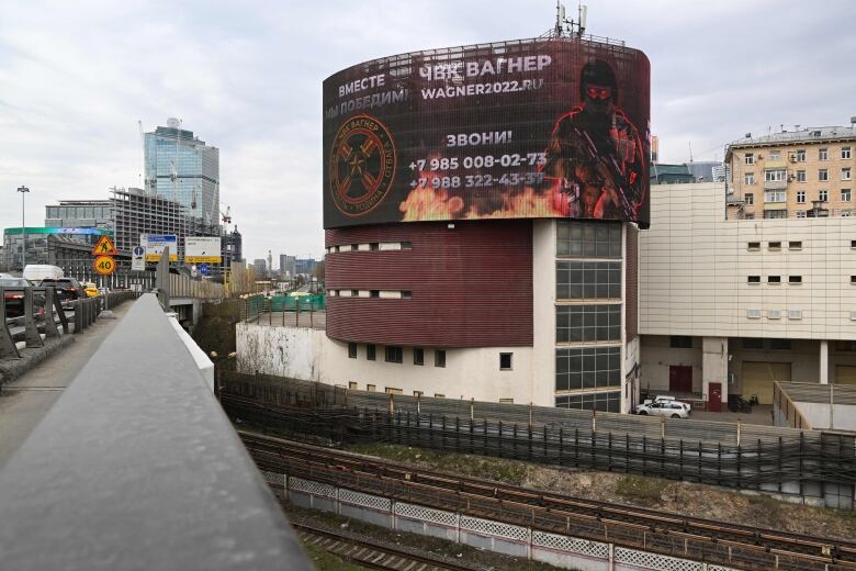 An outdoor billboard is shown in an urban setting.