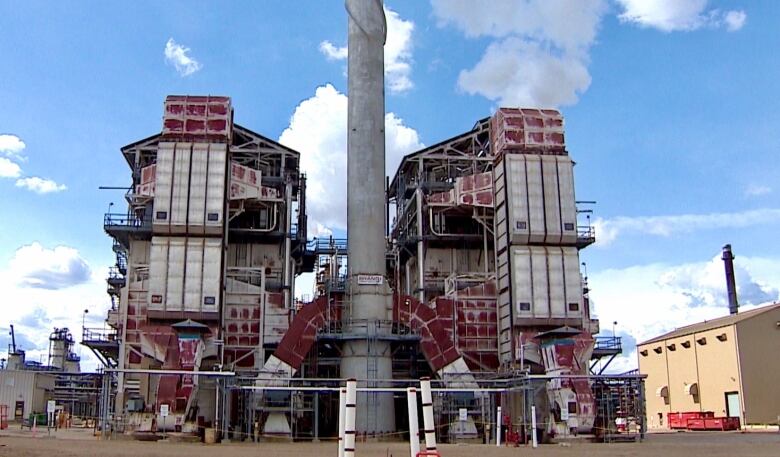 A large red and grey industrial facility is shown.