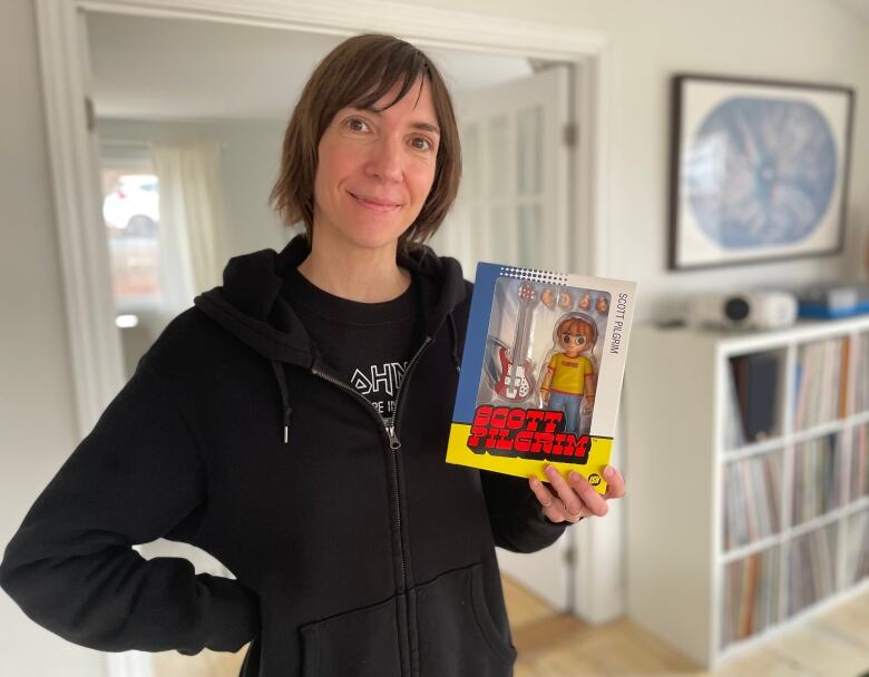 Carla Gillis with a Scott Pilgrim figurine in her house