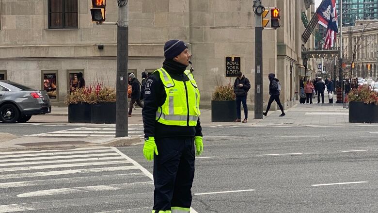 A traffic agent stands at a Toronto intersection