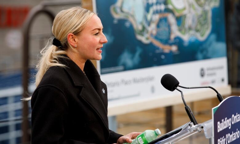 Ontario Infrastructure Minister Kinga Surma stands at a podium at Ontario Place.