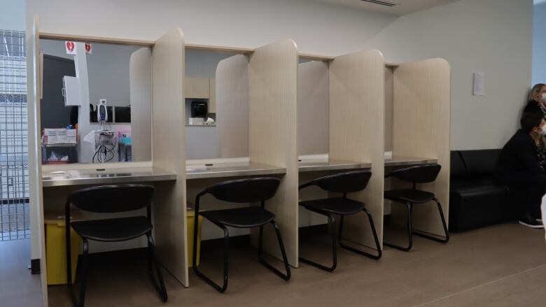 Several booths with chairs behind desks. 