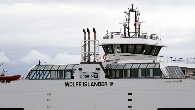 A close-up picture of the bridge of a white ferry with the words 