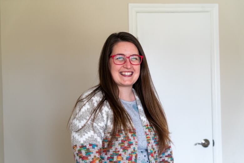 A young woman with red glasses.