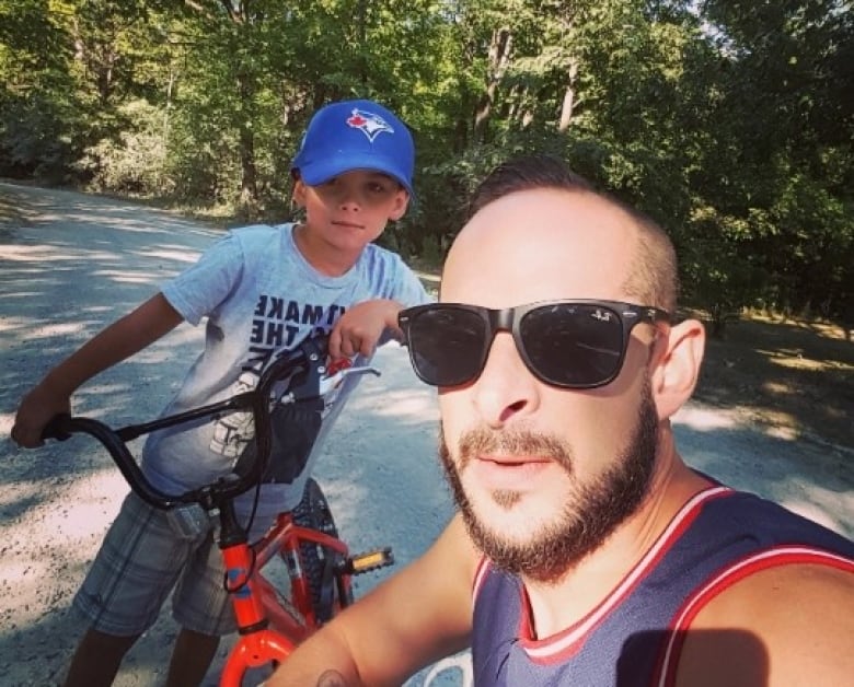 Jason Proulx (right) and son Tyson pose in a photo taken before the dog attack. Proulx says Tyson will likely have scars on his face for the rest of his life. 