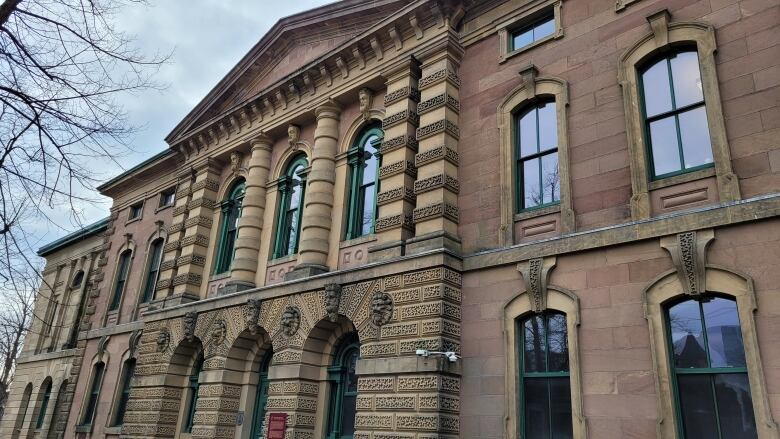 The front of the Halifax youth court building is shown with a cloudy sky above.