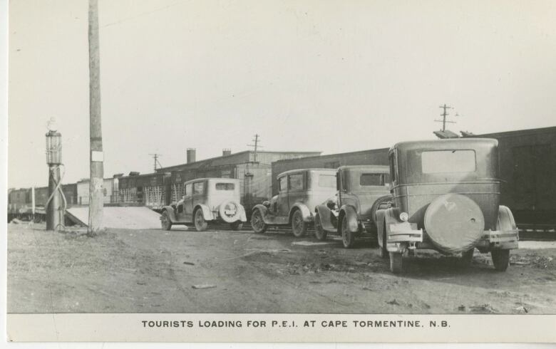 old postcard from 1920s showing cars lined up to get on a ferry