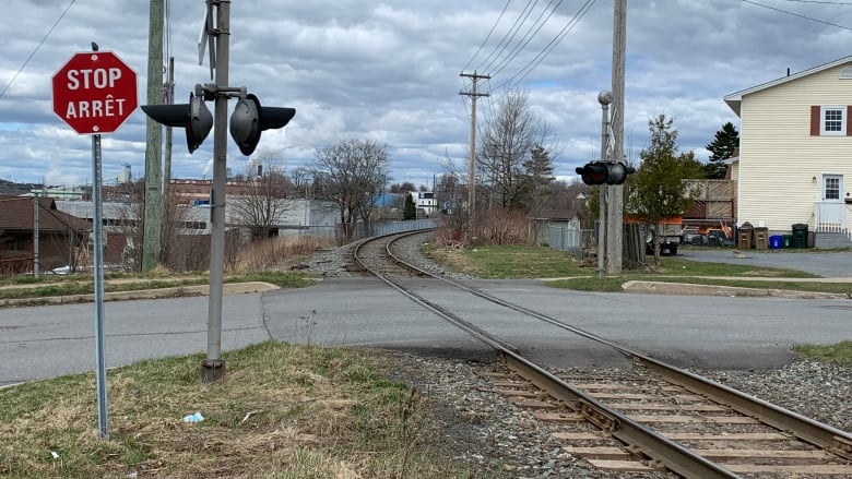 Railway crossing crosses a residential street.