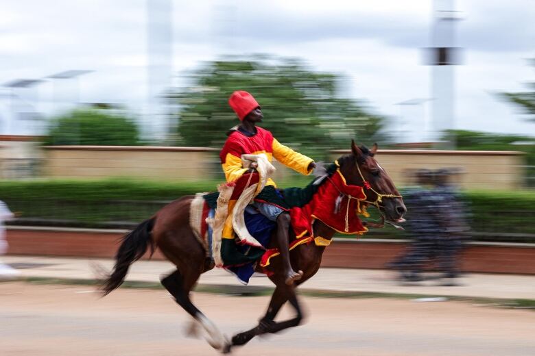 A young man rides a horse 