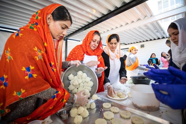 A person prepares food during the Vaisakhi parade in Surrey, British Columbia on Saturday, April 20, 2019.