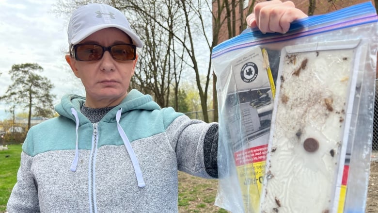 Tammy Brooks with a plastic bag that contains bugs that neighbour found in their suite. Brooks has had her apartment sprayed for cockroaches, which she said are a persistent problem at the building operated by Middlesex London Community Housing.