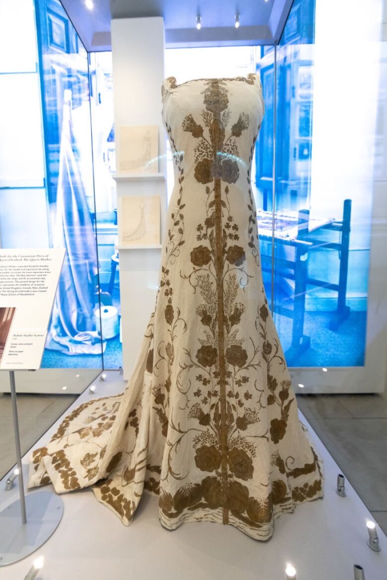 A early version of a finished gown is displayed on a mannequin.