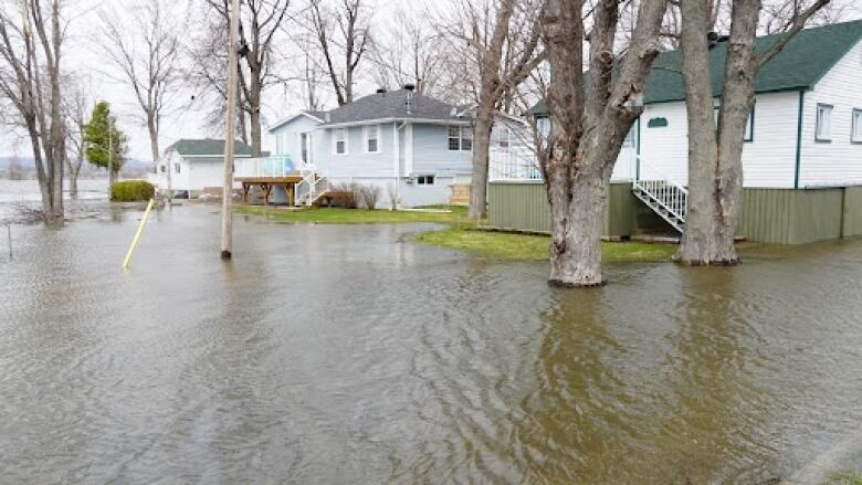 Flood waters surround a group of homes 