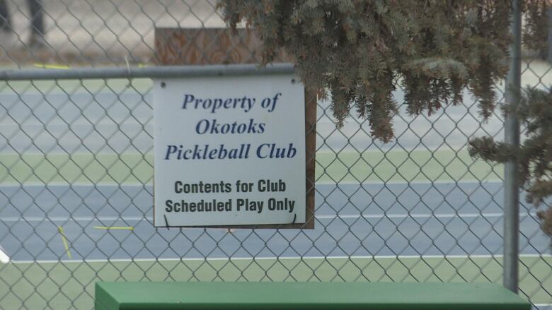 A sign that reads property of Okotoks Pickleball Club is pictured.