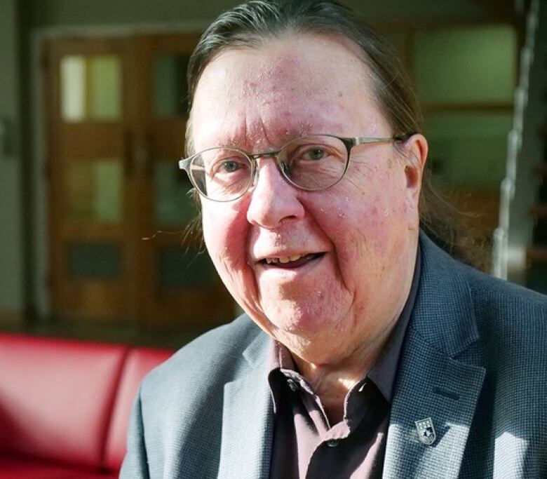 Man posing for a headshot while sitting down