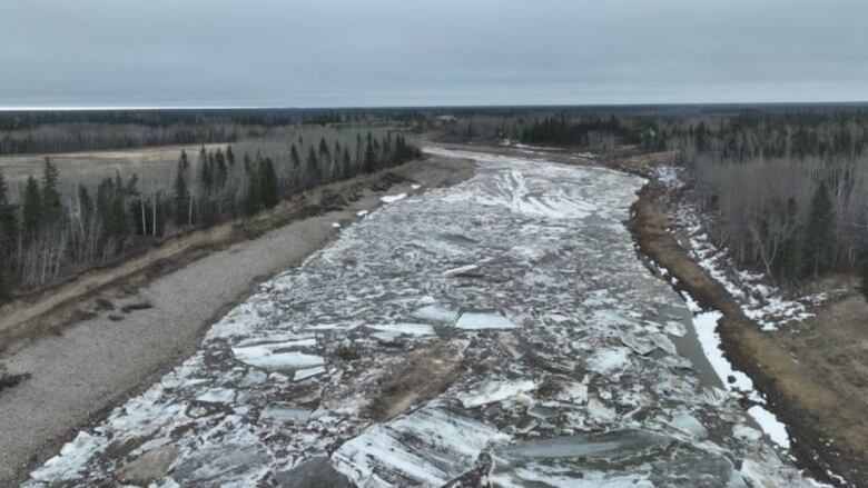 Large chunks of ice crowd the surface of a river.