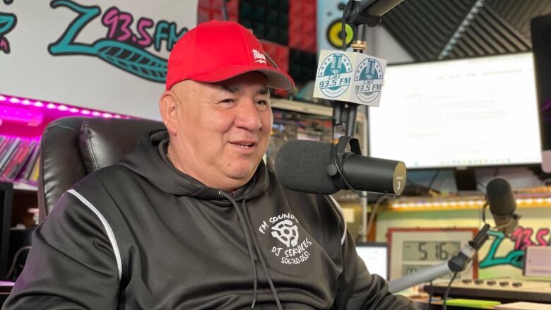 Floyd Metallic behind the microphone in his small radio station in Listuguj First Nation, Quebec.