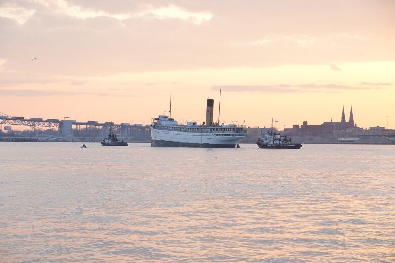 A ship in the Detroit River at sunset. 