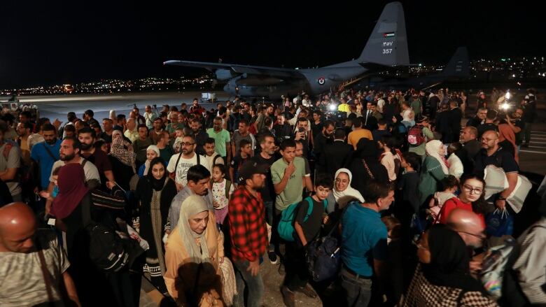 Jordanians evacuated from Sudan arrive at a military airport in Amman, Jordan, Monday, April 24, 2023.