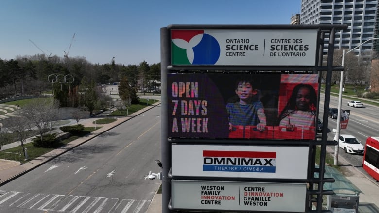 A drone shot of the science centre sign and road. 