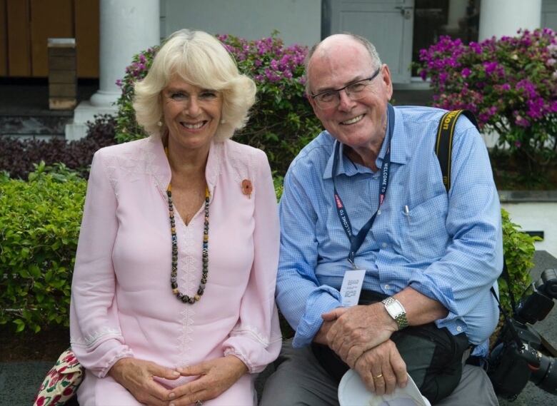 Arthur Edwards sits alongside Camilla, then the Duchess of Cornwall,  during a break from a Royal visit to Indonesia in 2017.