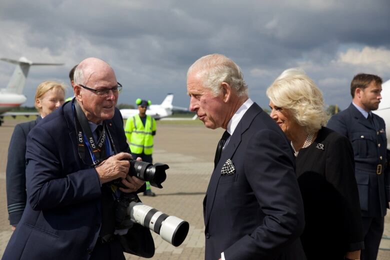 Arthur Edwards offers his condolences to King Charles and Camilla,  Queen Consort,  on the runway at RAF Northolt after the family returned to London following the Queen's death.