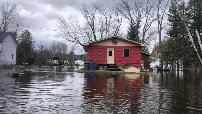 A house stands in a flooded neighbourhood