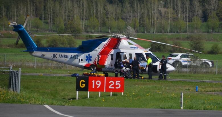 A helicopter with the words 'Air Ambulance' is seen at an airport.