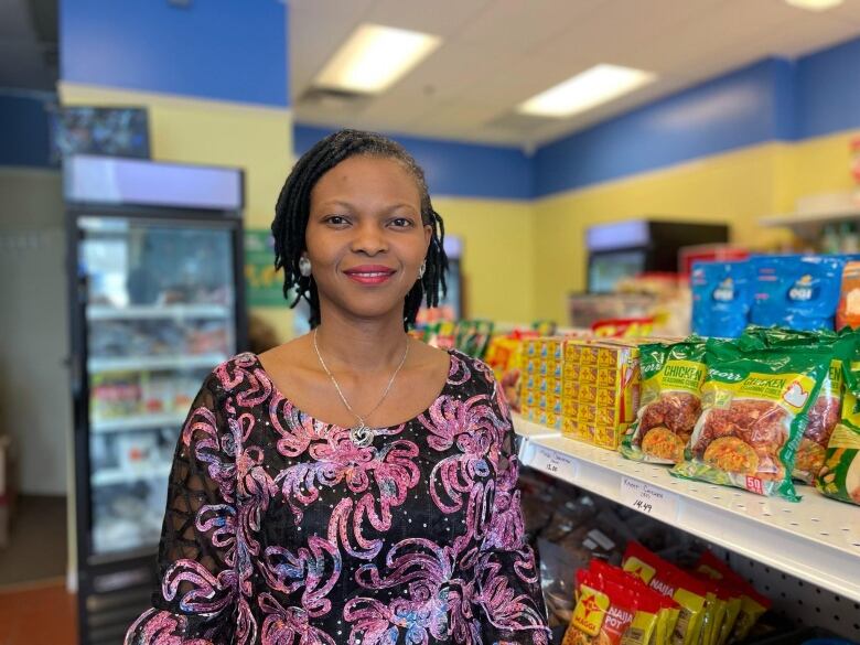 A woman standing inside a grocery store