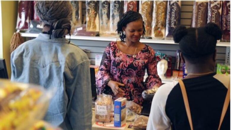 A female sales representative attending to two female customers 