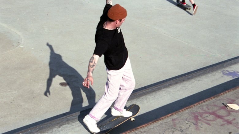 A skateboarder in the Halifax Common doing a trick 