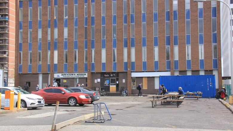 A brick building and parking lot. 