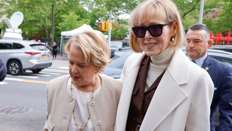 Woman in a white jacket and sunglasses