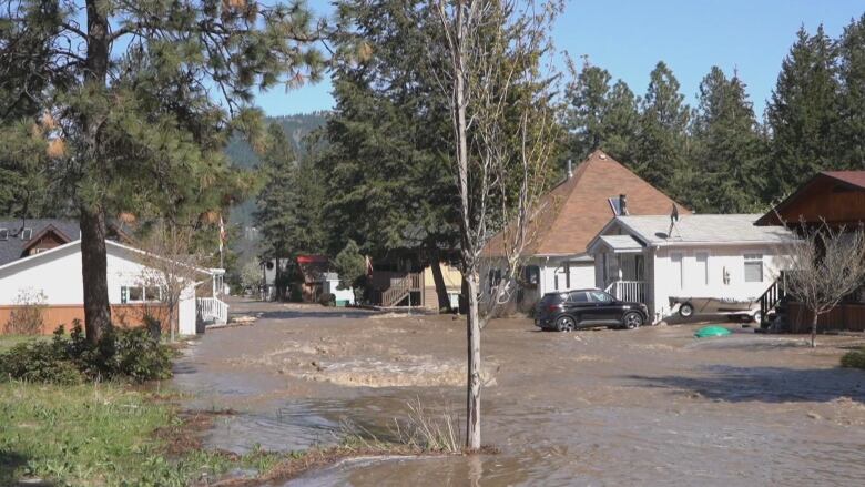 A residential street is pictured with pooled water.