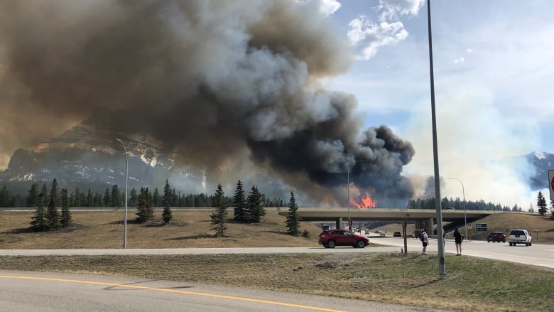 a highway with smoke and fire visible in the vicinity