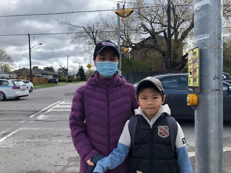 Kiki Li and Jian Li say they are nervous crossing the street after nearly being hit a year ago. They tell CBC they want a crossing guard at Caledonia Road and Playfair Ave.