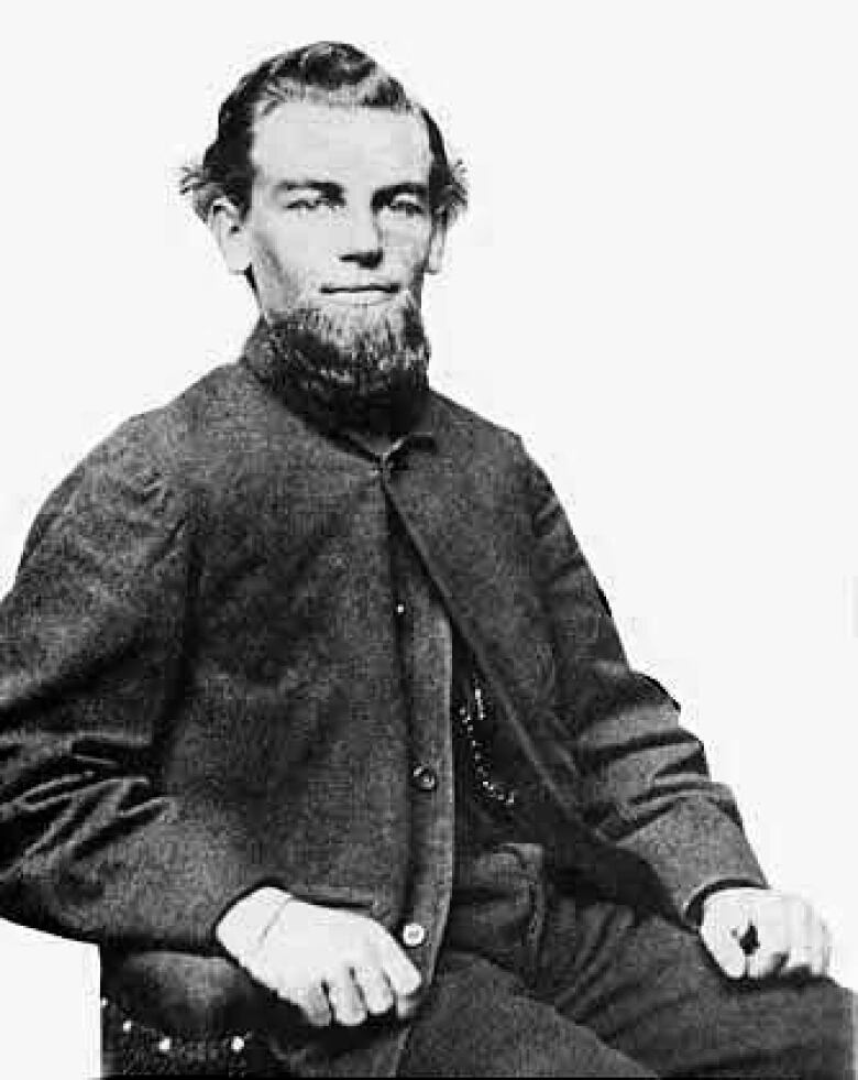 A photograph of a distinguished man with a beard in a high collared jacket.