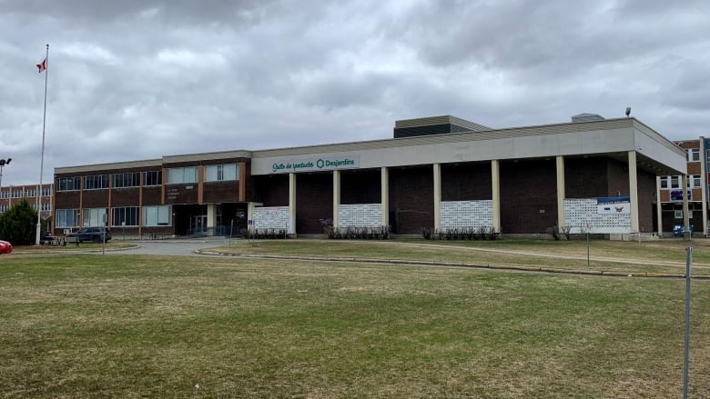 A school stands across from a lot.