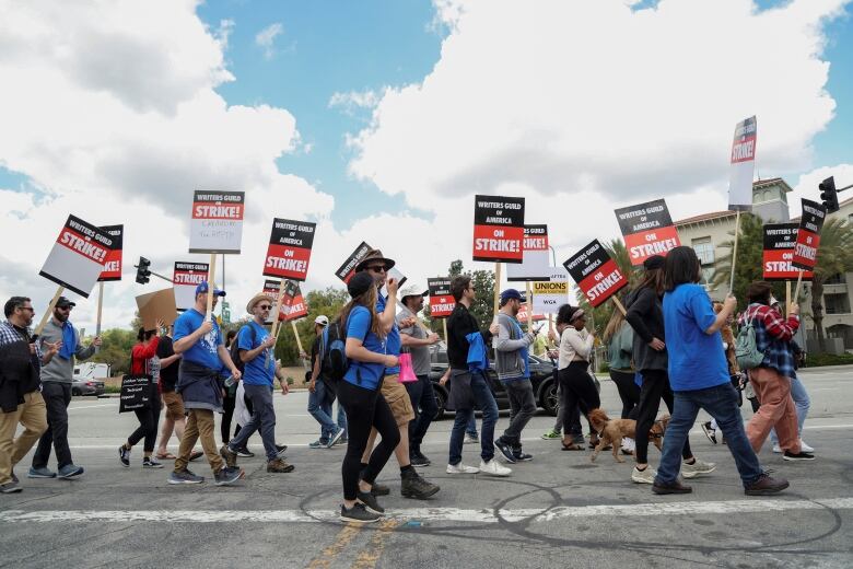 Hollywood writers picket over pay and AI restrictions.