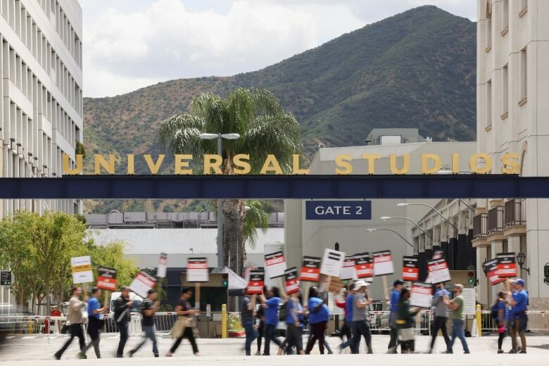 Hollywood writers picket for job security, pay, residuals and to artificial intelligence restrictions at Universal Studios in California.