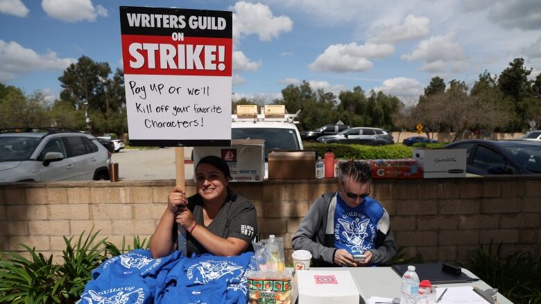 Strikers sit in front of Universal studios during the writer's striks