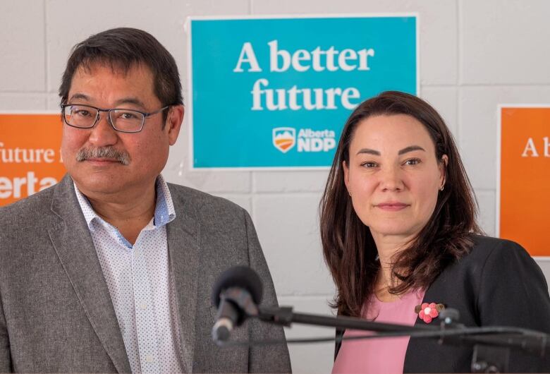 Two people standing at a podium. 