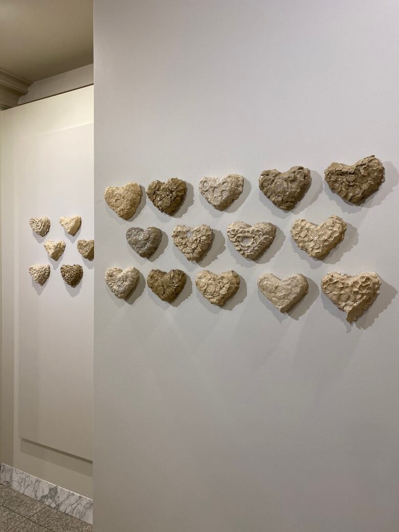 The Heart Spirit Exbibit to honor an Indigenous person who is missing or was murdered, with 200 handmade clay hearts, facilitated by artist Cheryl Ring.