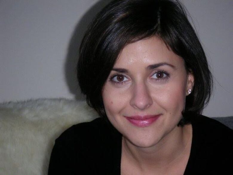 A woman with dark hair poses for a headshot.